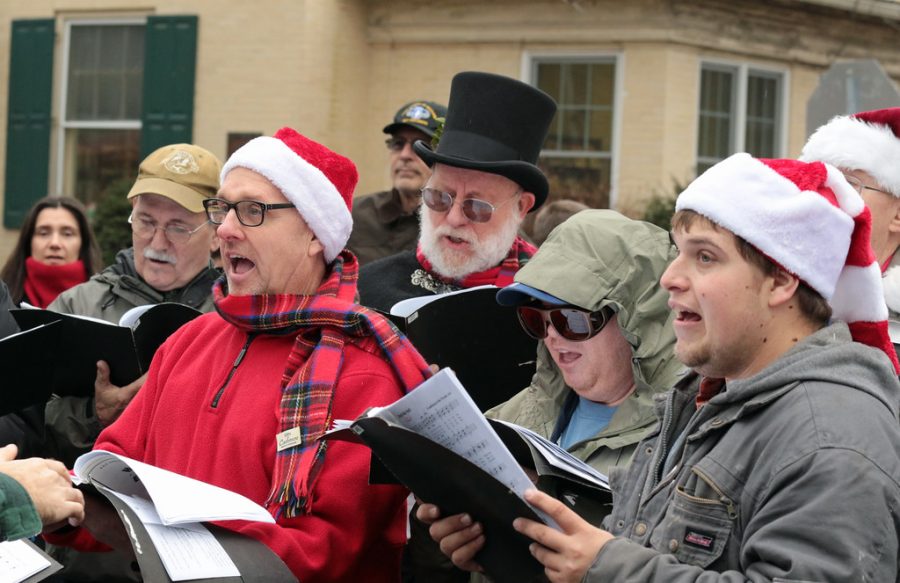 Pictured is a more modern form of Christmas caroling. People go out in groups and sing holiday songs.