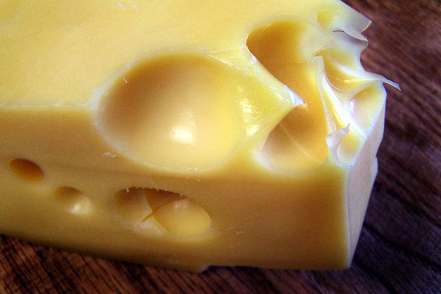 Pictured is Swiss cheese, and its many holes due to carbon dioxide. Its known for having a sharp smell and flavor. 