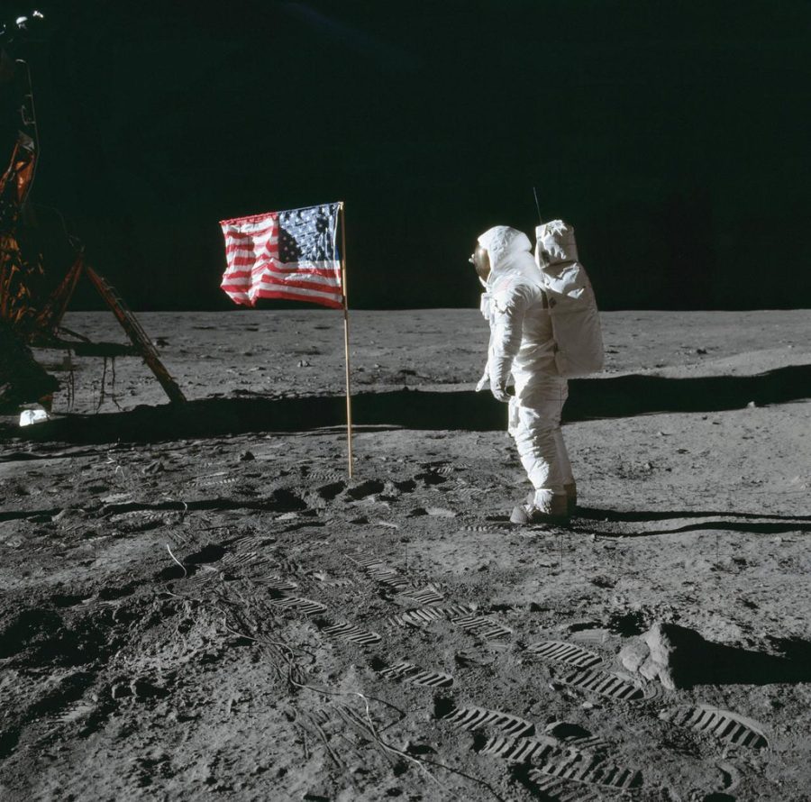Pictured+is+the+view+from+the+first+moon+landing+in+1969.+Buzz+Aldrin+is+seen+next+to+an+American+flag+planted+in+the+ground.