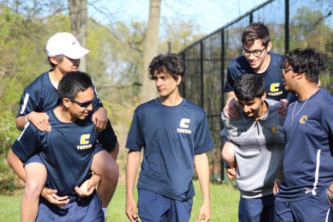 Across the tennis courts, players Joshua Vivas, Ivan Chu, Daniel Sherman, Mateus Pessanha, Dev Pujara, and Brendan Parmar groups together to discuss and show support for each other. 