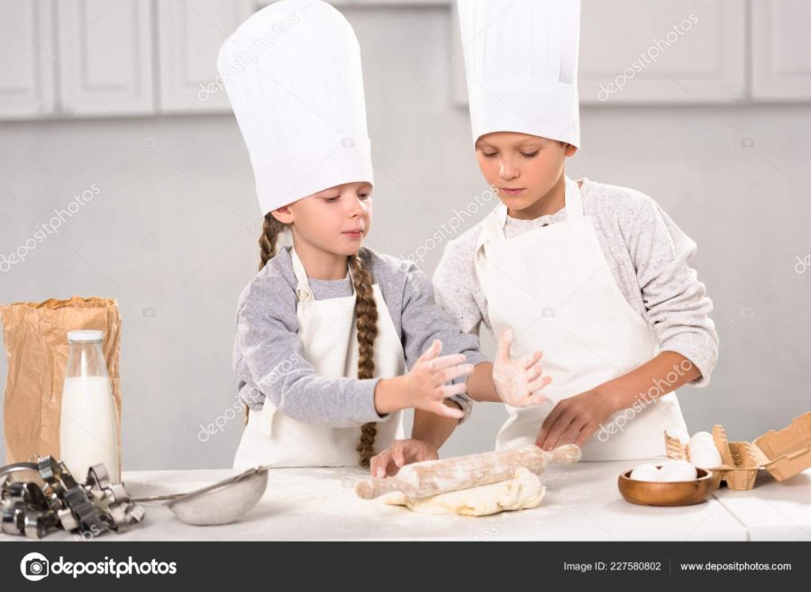 Pictured are children wearing standard gourmet chef hats. The pleated lines in the hat have significance in the restaurant industry.
