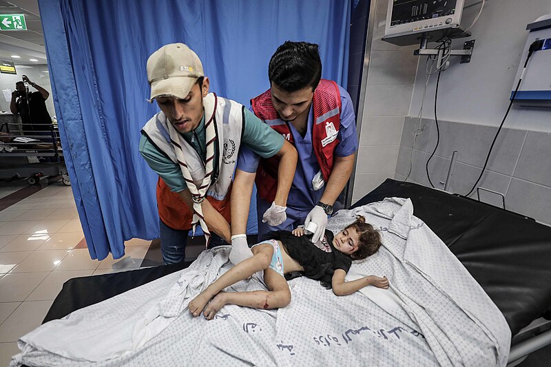 A child is being treated in the damaged Al-Shifa Hospital after an Israeli airstrike, October 2023