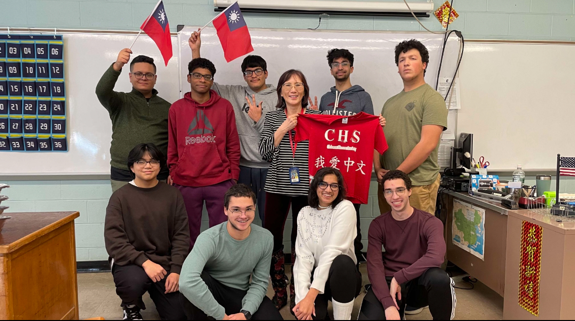 During the Chinese Fours class last day, the class gathered together around teacher Yau-Wen Lin. The class held the Taiwan flag to represent where Lin grew up in. 