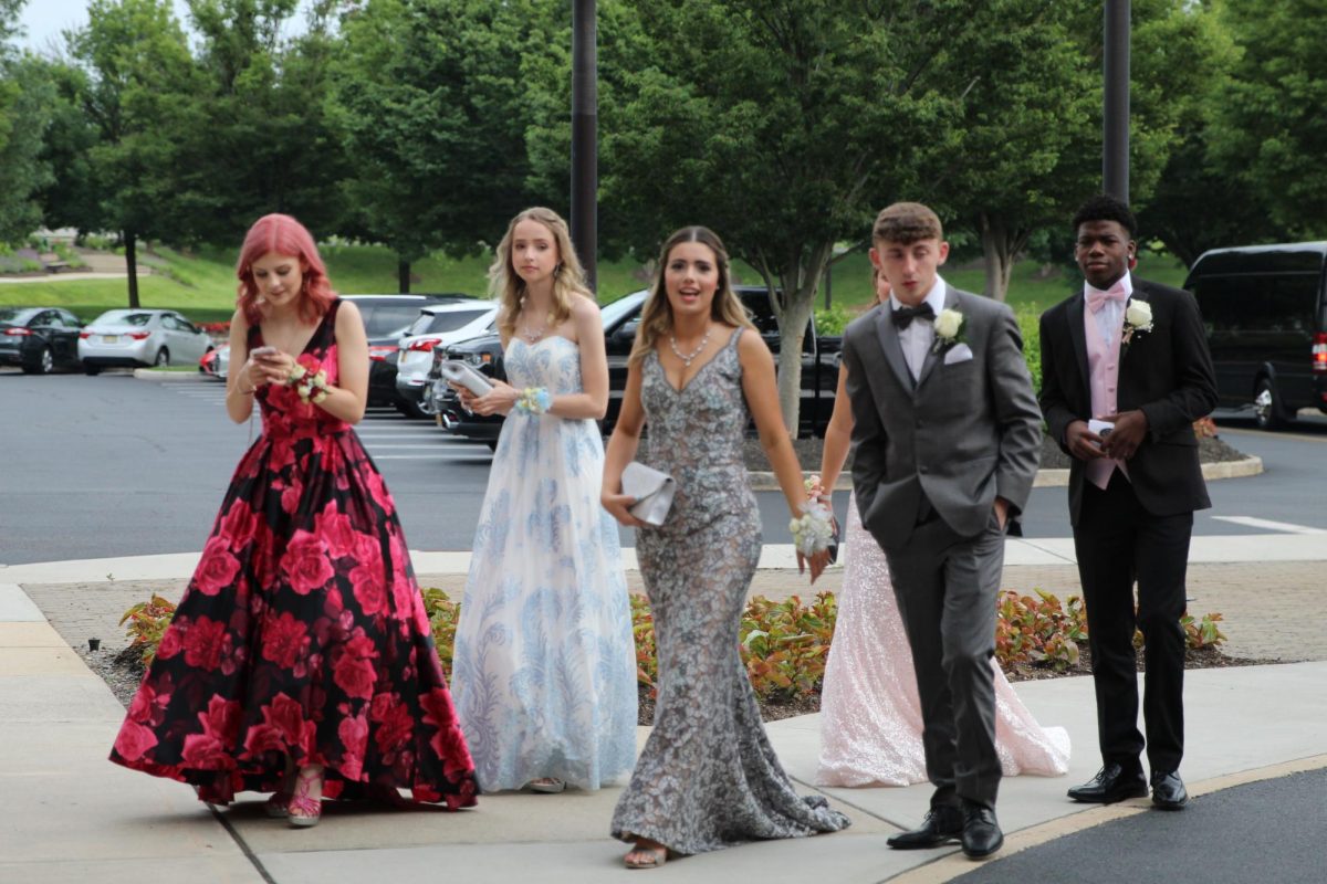 Walking+into+prom%2C+one+can+see+the+various+colors%2C+styles%2C+shapes%2C+and+cuts+to+the+dresses.+Some+dresses+can+be+simple%2C+whereas+others+can+be+over-the-top.