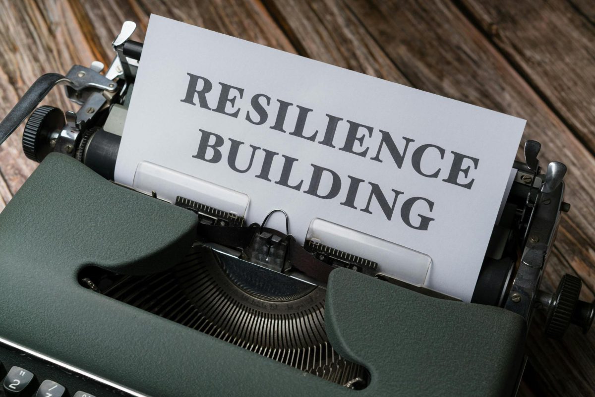 A typewriter with the word resilience building on it. 