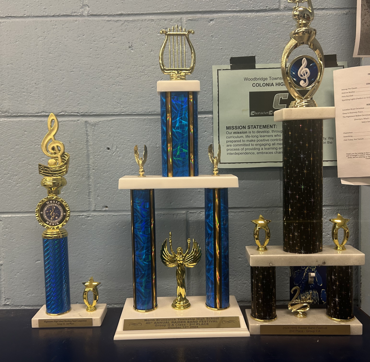 Various trophies won by the Colonia High School Marching Patriots. The Patriots took home silver at each marching band competition.