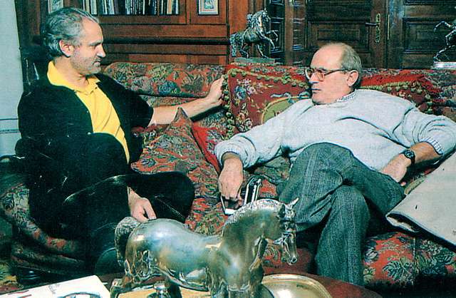 This picture was taking in 1990, the location of said image is Milano Italy. Mario Biondi is on the left interviewing Gianni Versace who is on the right. 