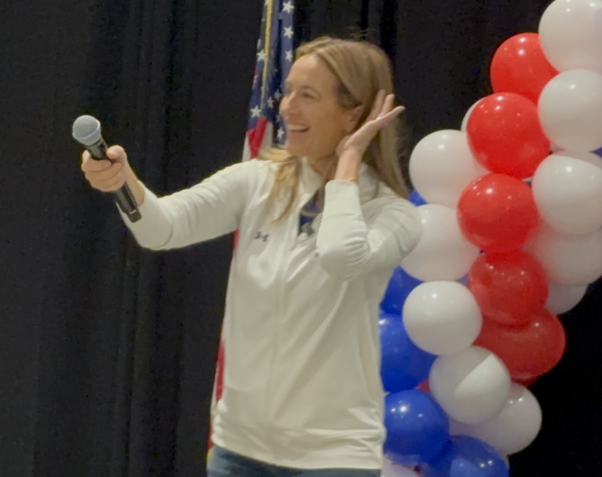 Pointing the microphone at the crowd, U.S. Congresswoman Mikie Sherrill smiles at the turnout for her final rally at Middlesex County College. New Jersey Democrats gather together in support to cheer her on to the gubernatorial election day.