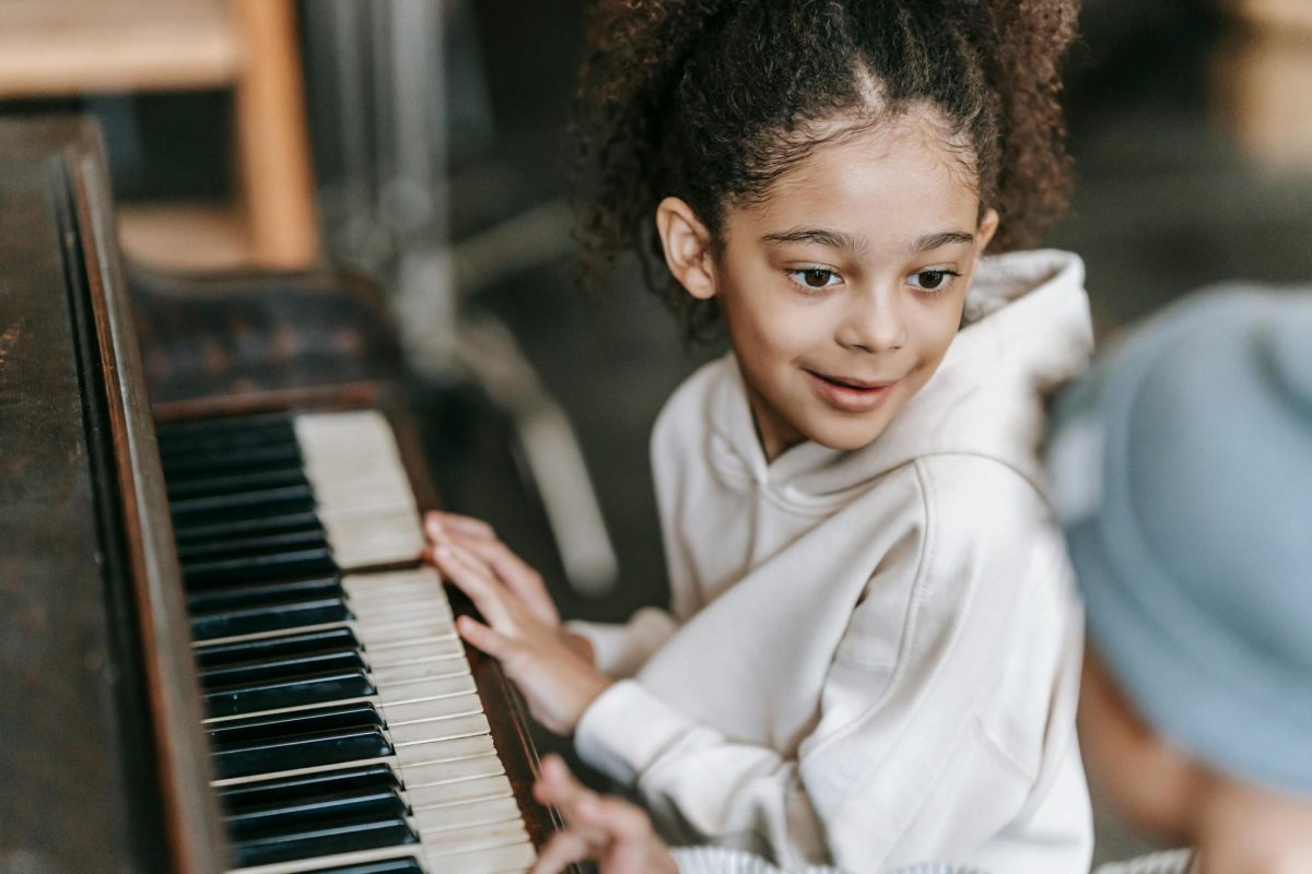 A little boy exploring the art of the piano, learning notes and figuring out how to put them togther to create a beautiful melody.