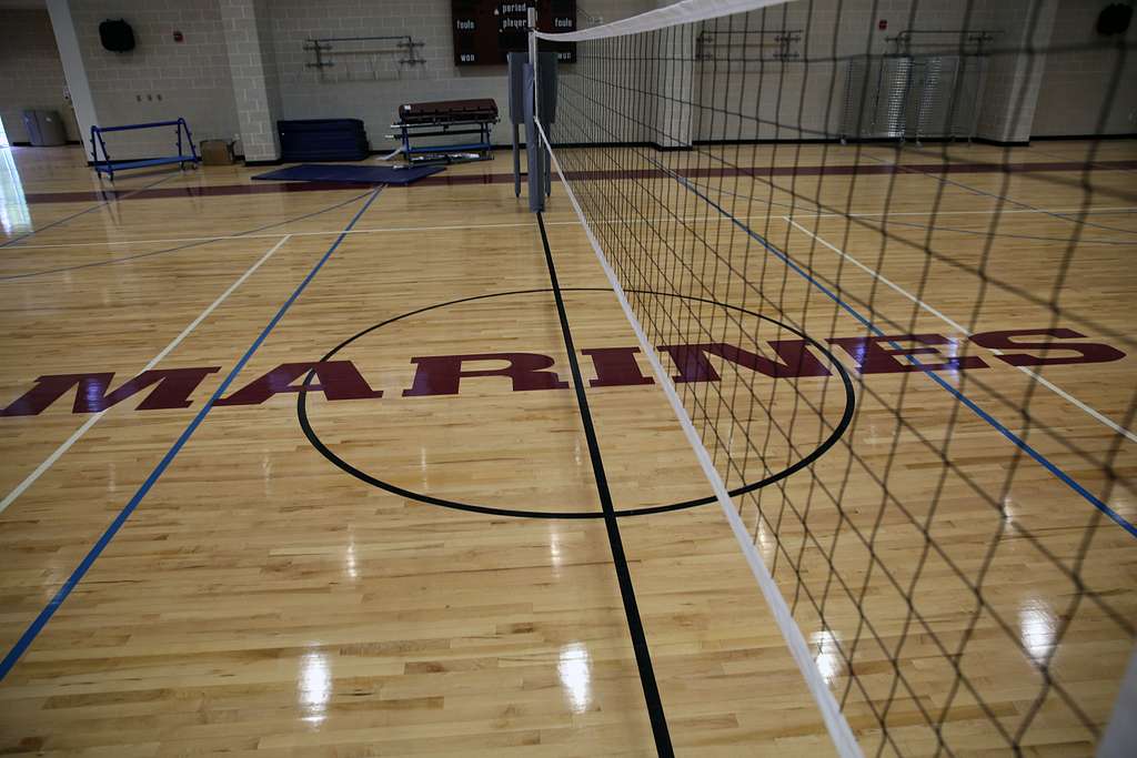 The net is tightened and the polished hardwood floor is swept at this premier indoor volleyball facility. With regulation lines clearly marked and professional-grade equipment in place, the court is primed for high-intensity competition.